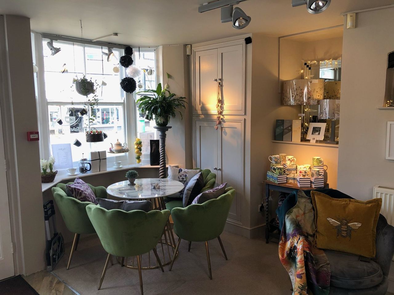 Green chairs and a café table surrounded by gifts at 4 You From Me