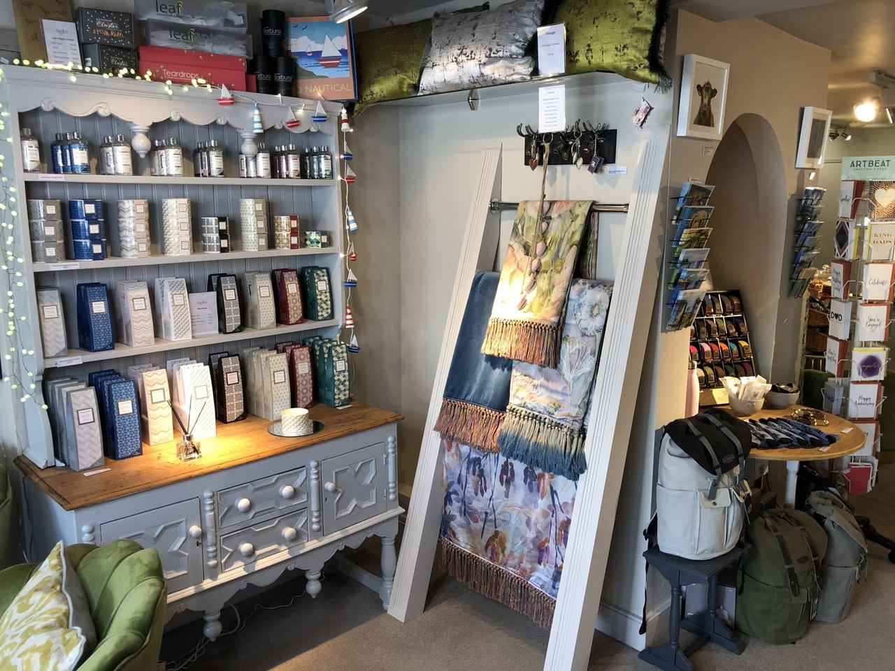 Shelves of candles and gifts in the Honiton shop