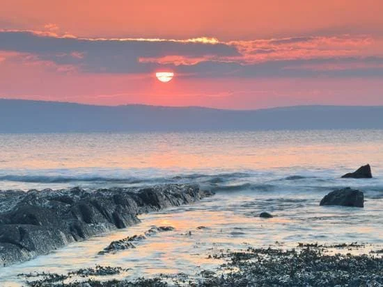 Evening light across the sea from Abbotsham Cliffs