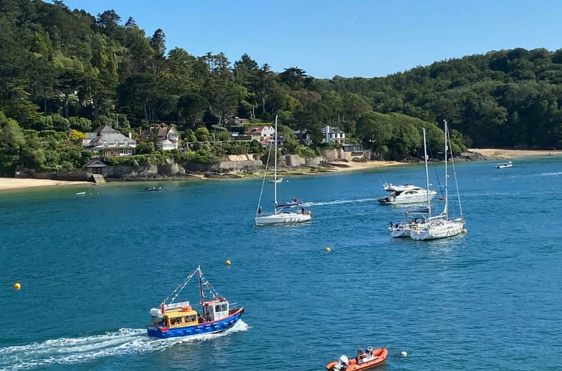 Moored boats and wooded shores on the Salcombe estuary