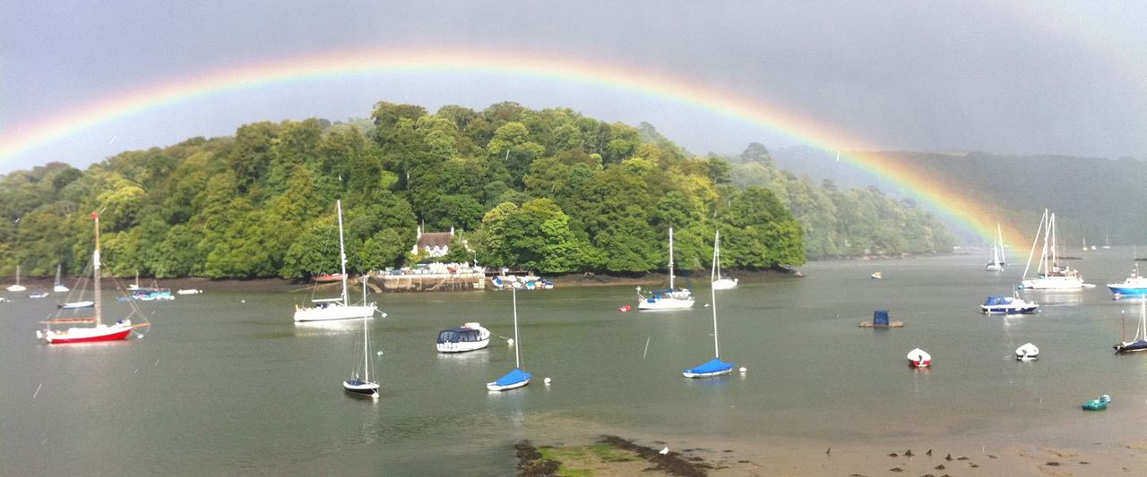 A rainbow over moored boats on the Dart