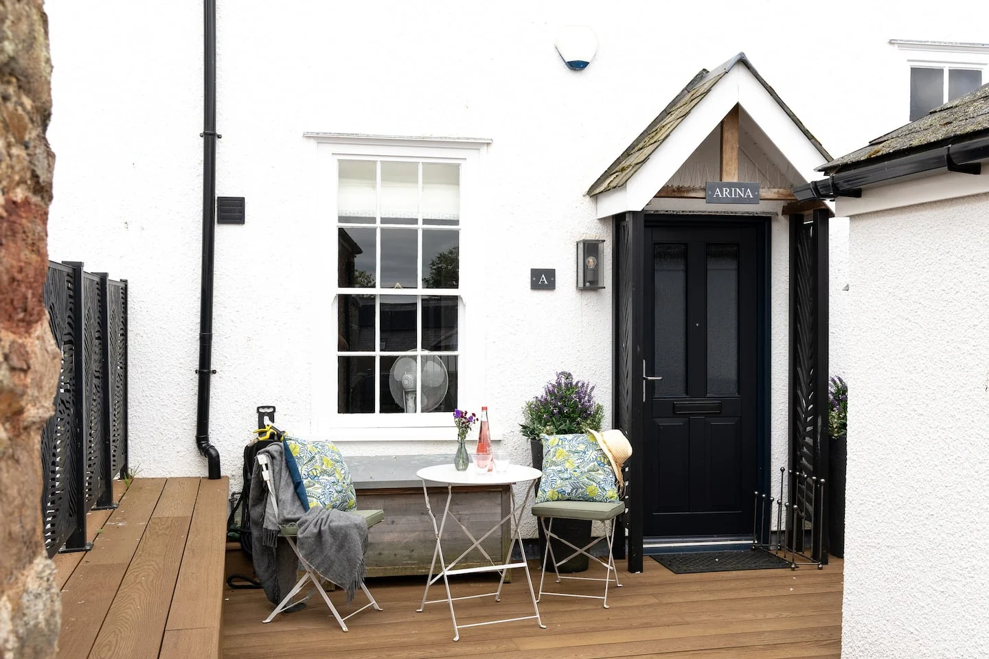 Small outdoor table beside Arina’s entrance