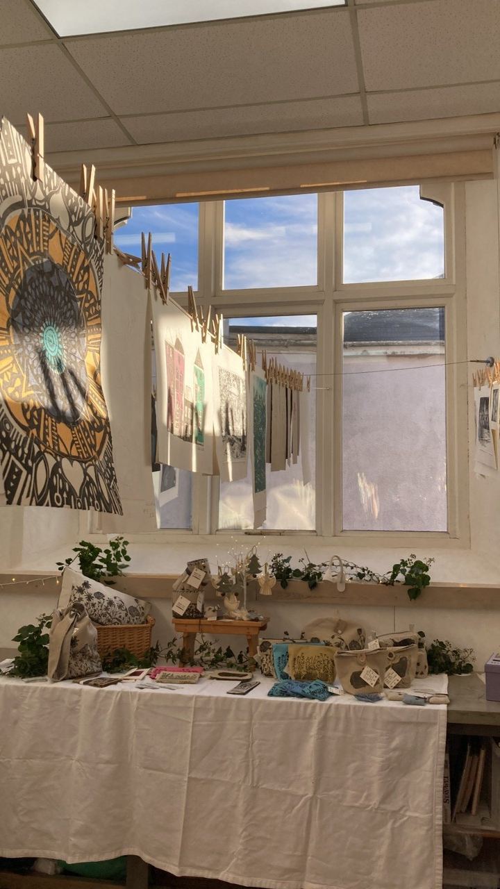 A light-filled room with tables set out at Art House South Brent