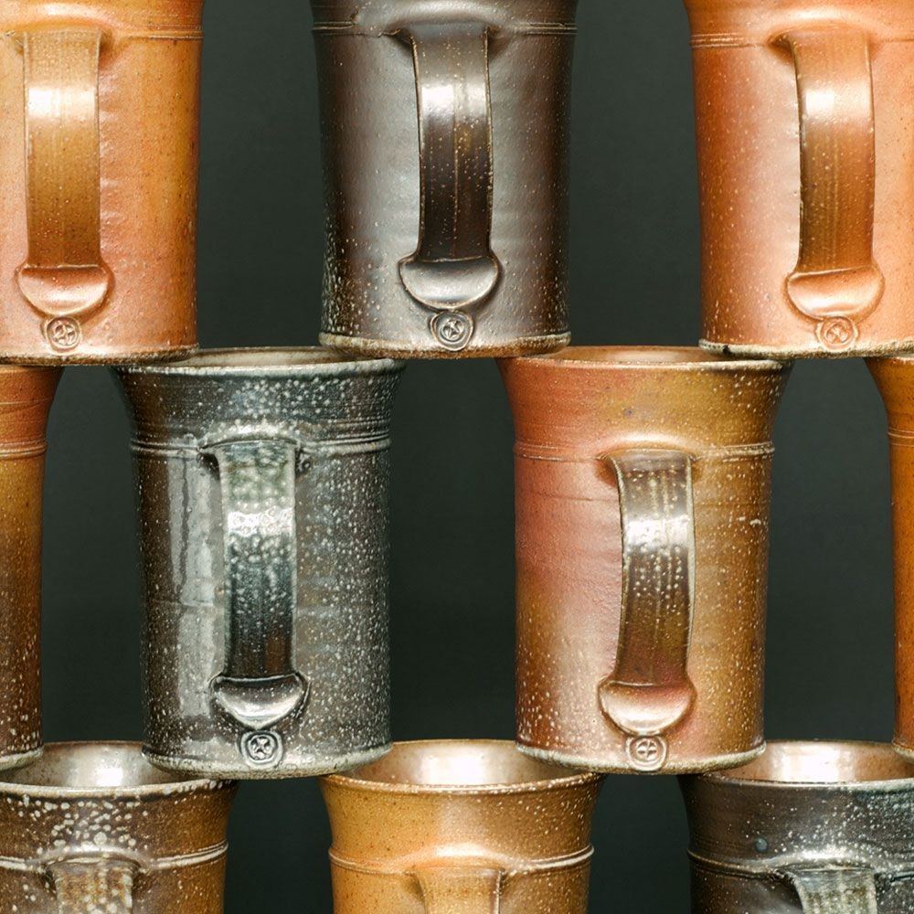 Stacked mugs with salt-glazed surfaces