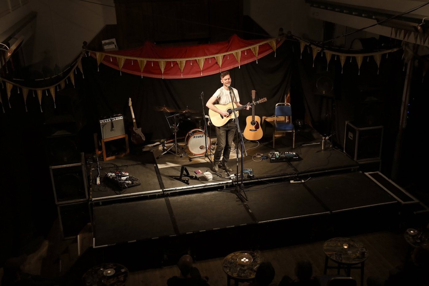 A balcony view of Chris Cleverley performing on the Arts Centre stage