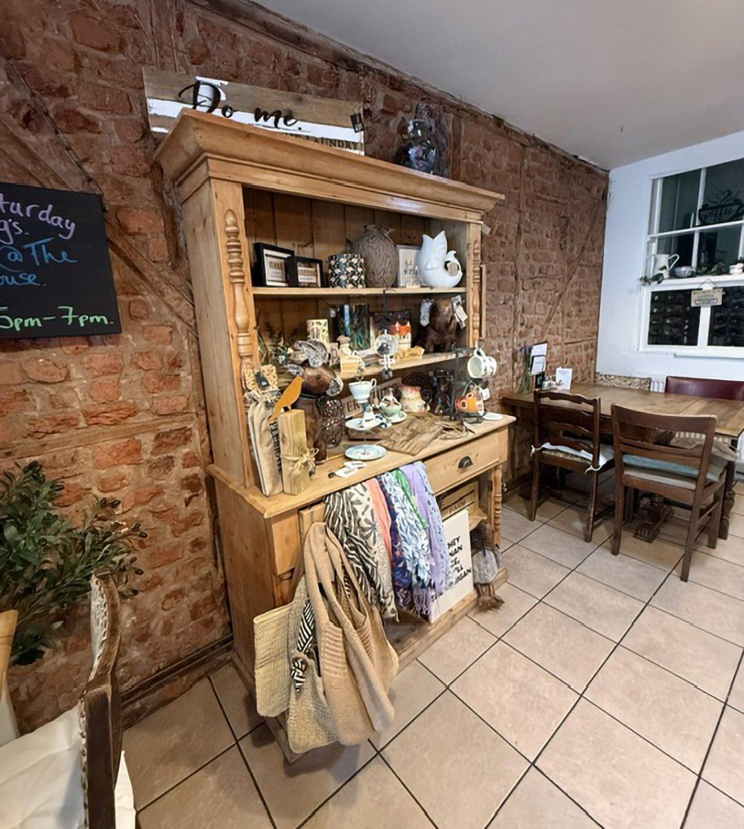 Brick walls and wooden dresser inside The Bakehouse
