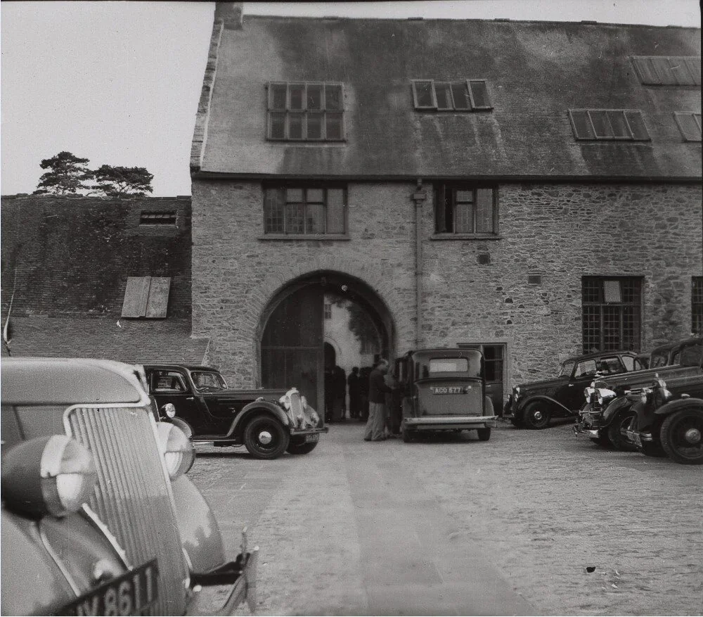 Historic black-and-white photograph of people and cars outside the Barn Theatre
