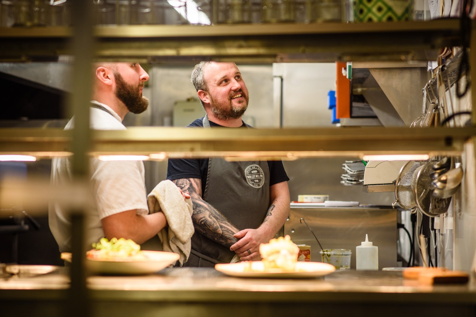 Chefs at work behind the kitchen pass at Bickley Mill Inn