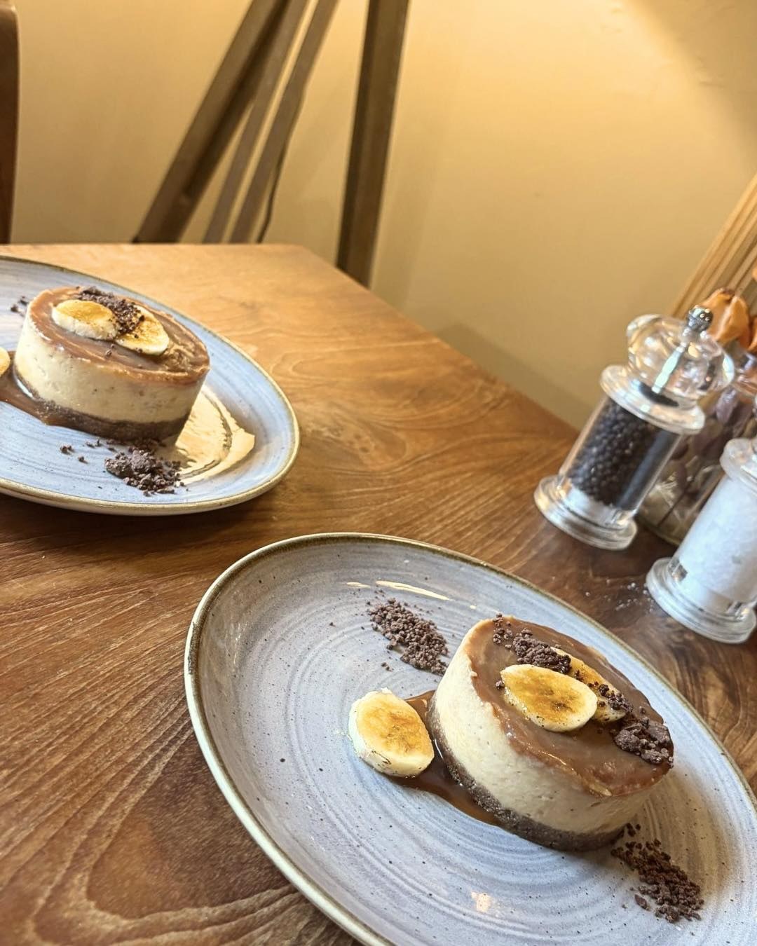 Two plated desserts on a wooden restaurant table at Bickley Mill Inn