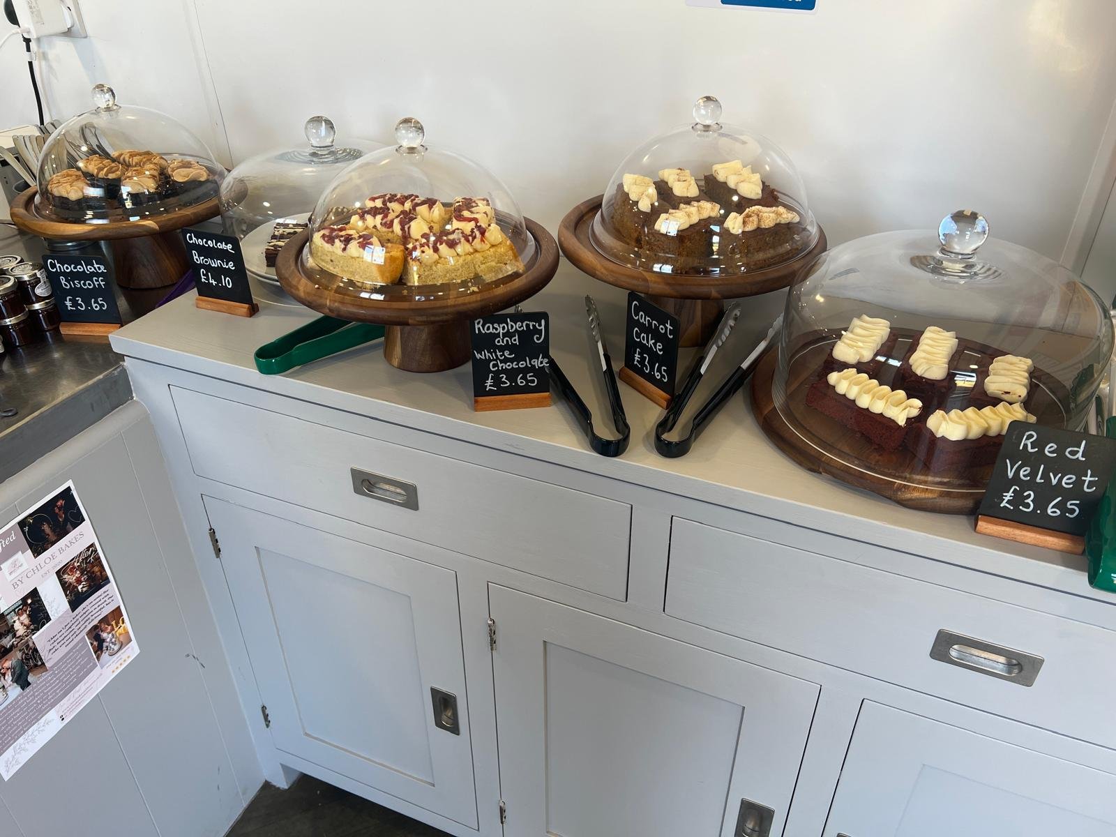 Cakes under glass domes on the Bloomin’ Lovely café counter