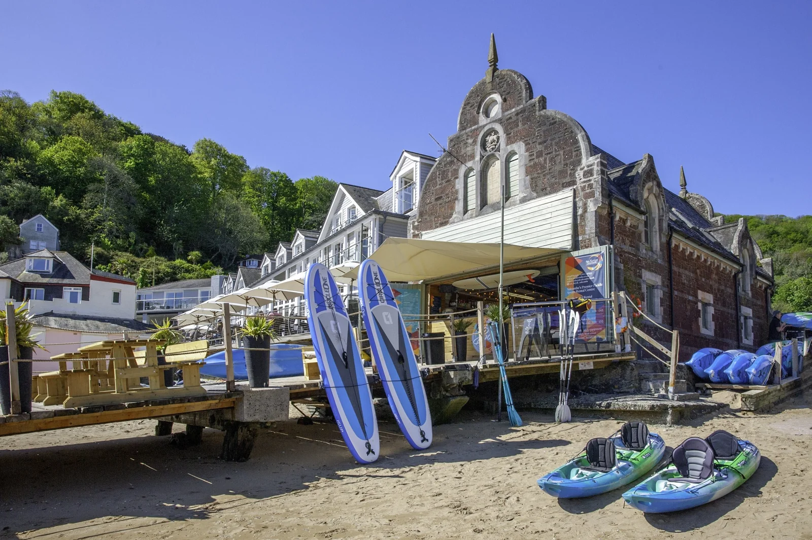 The old lifeboat house at South Sands with kayaks and boards outside