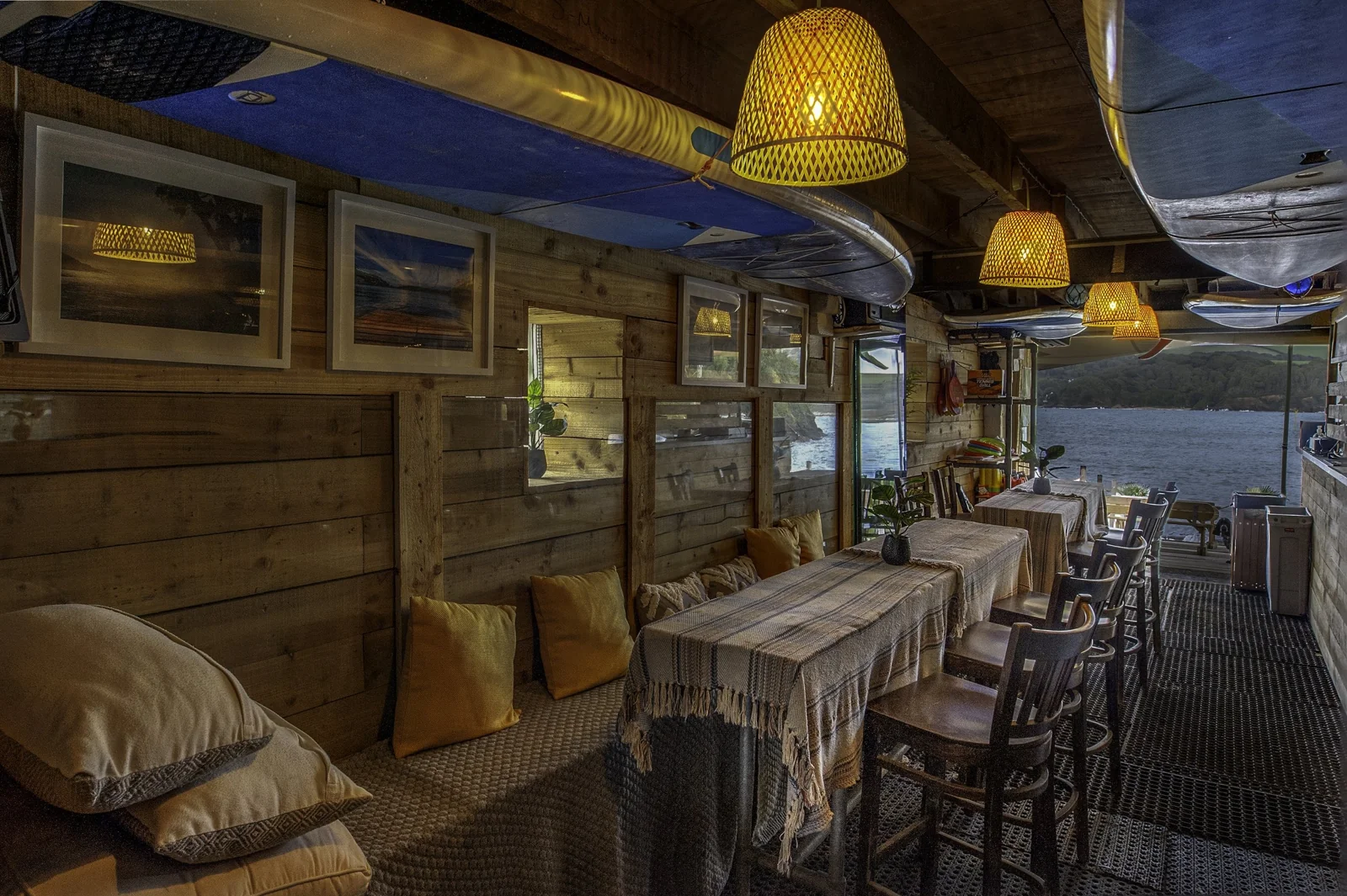 Bo’s Beach Café interior with timber walls and hanging lamps