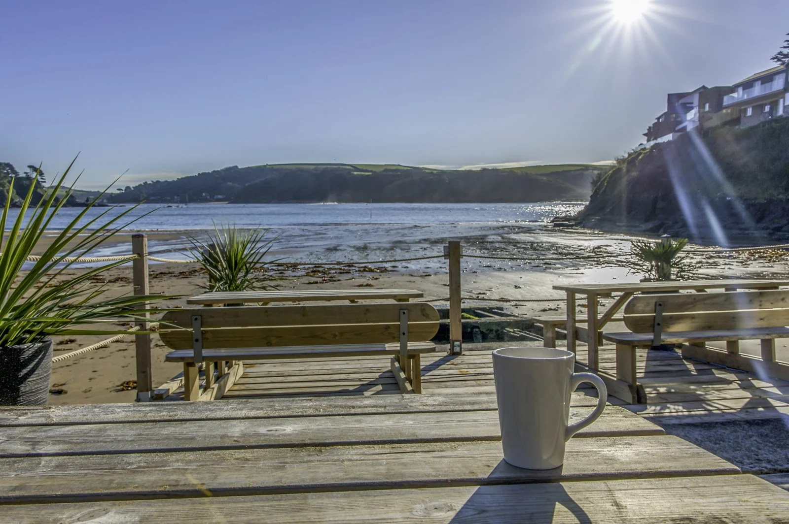 A mug on a seafront picnic table at South Sands