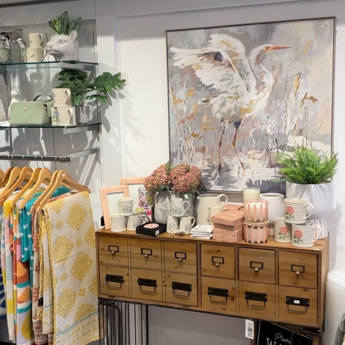 Artwork above a drawer cabinet with gifts and home accessories