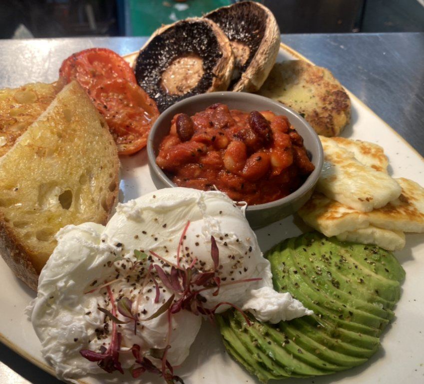 Vegetarian breakfast with toast, beans, avocado and eggs