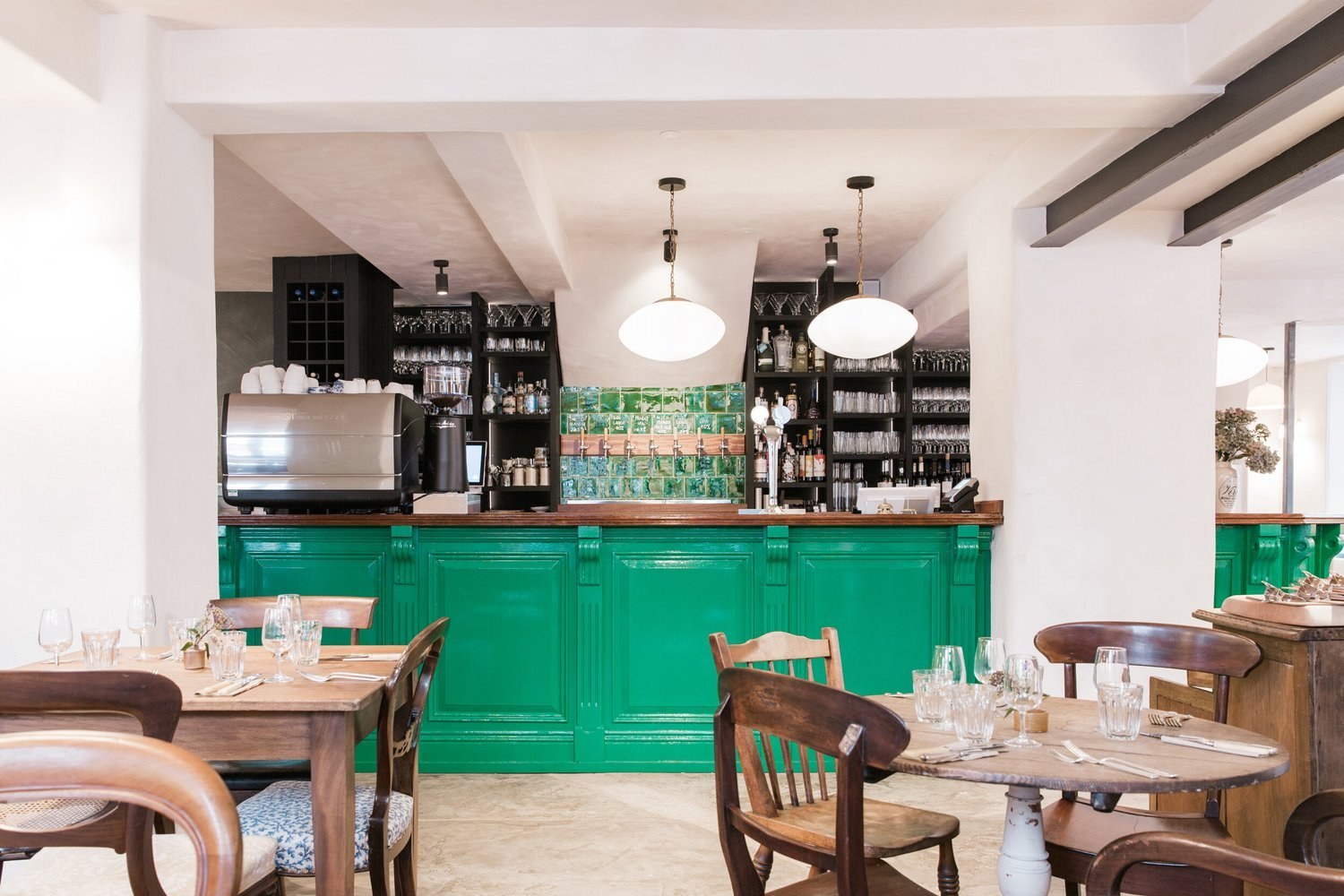 The Bull Inn dining room with its green bar and wooden tables