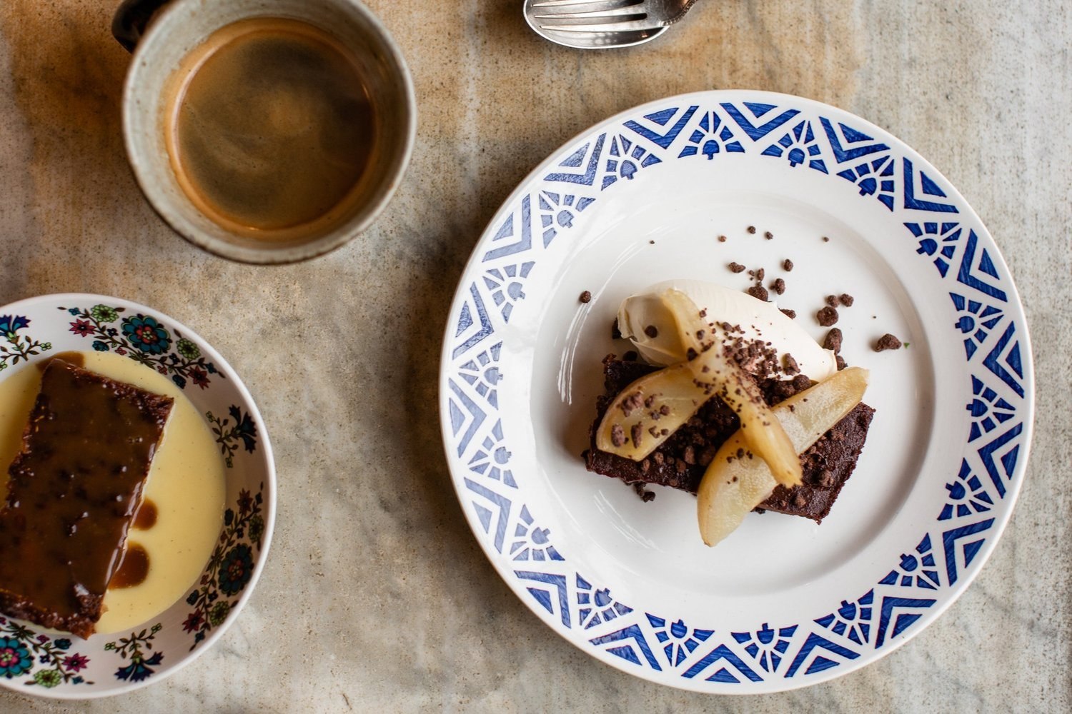 Dessert on patterned crockery beside coffee at The Bull Inn