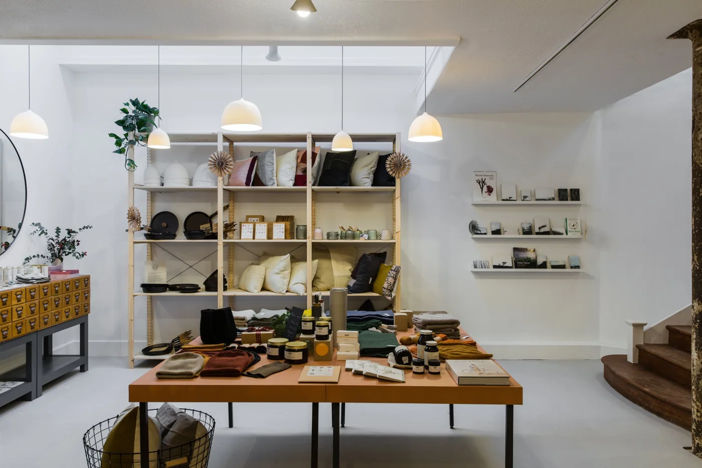 Light-filled Butterwalk shop with wooden display tables and shelves of homewares