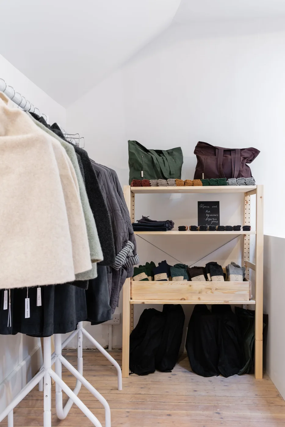 Rails of clothing and folded garments at Butterwalk