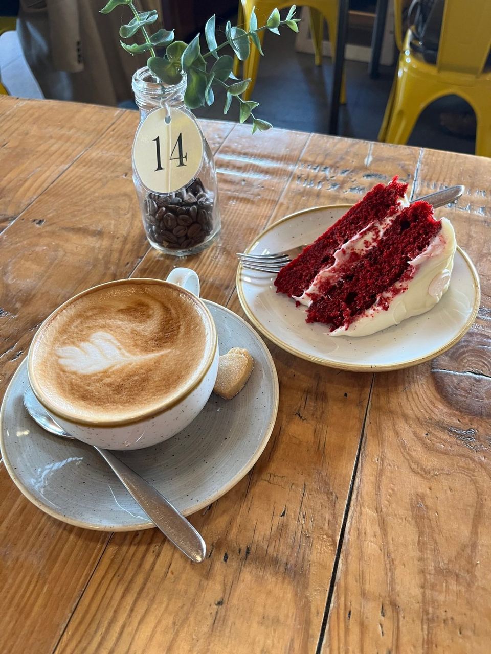 Coffee and cake on a wooden table at Cafe 3 Sixty
