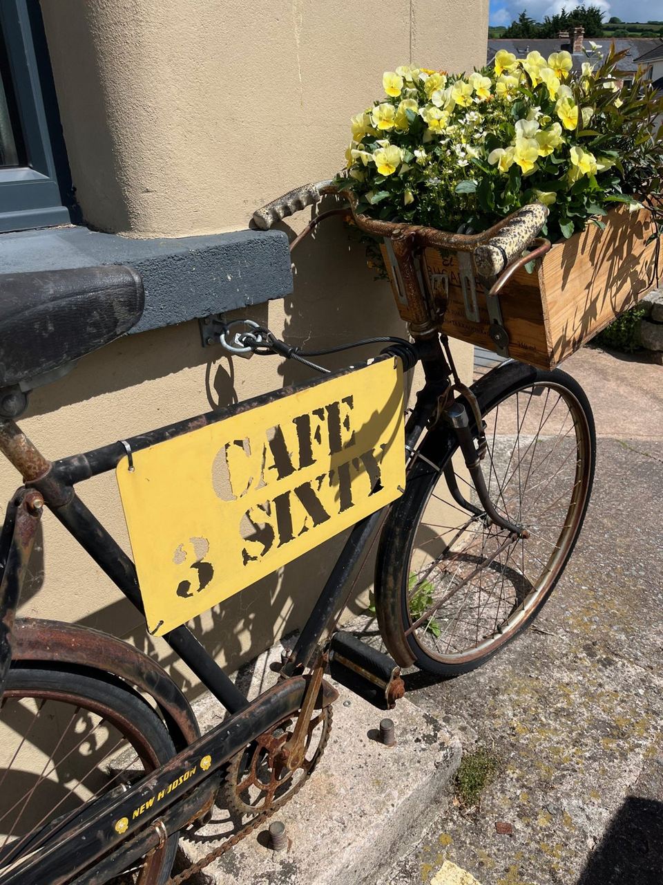 Flower-decorated bicycle outside Cafe 3 Sixty