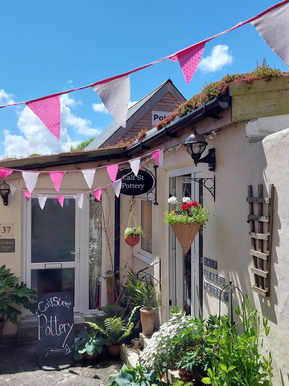 The pottery shopfront with bunting and flowers