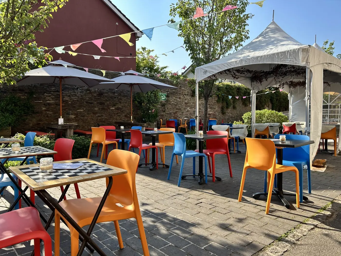 Colourful chairs and tables in Canteen’s sunny courtyard