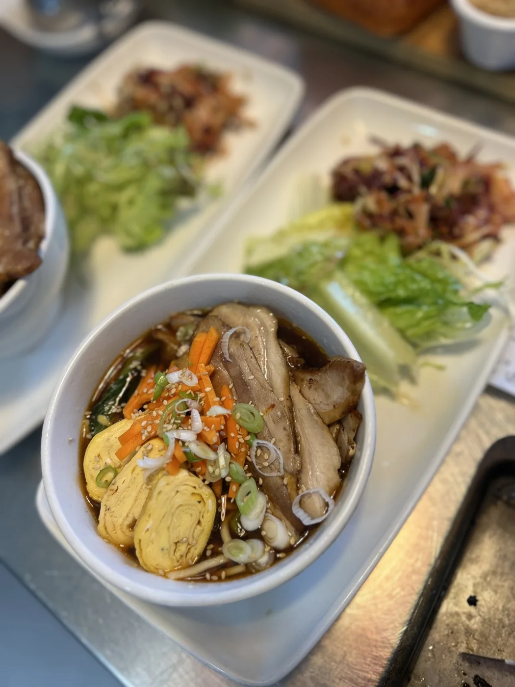 A noodle bowl and colourful plates at Canteen