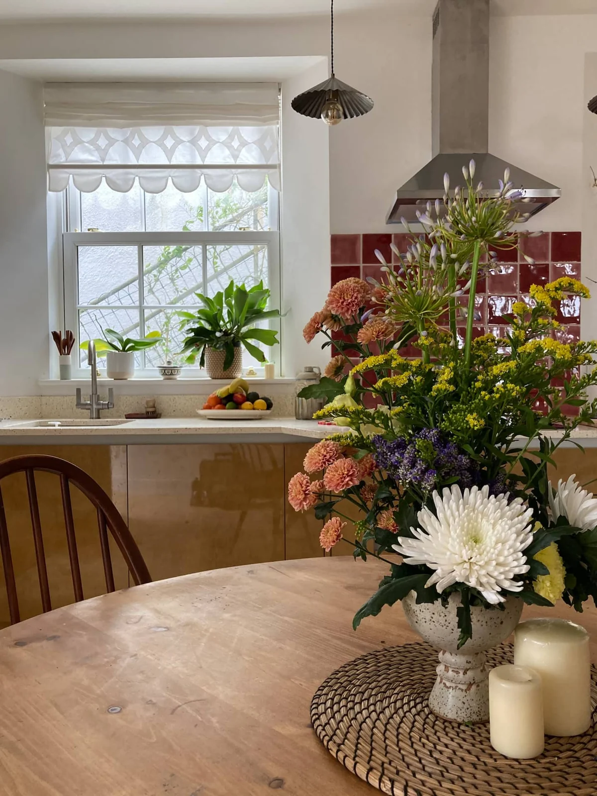 Flowers on the kitchen table beside a bright window