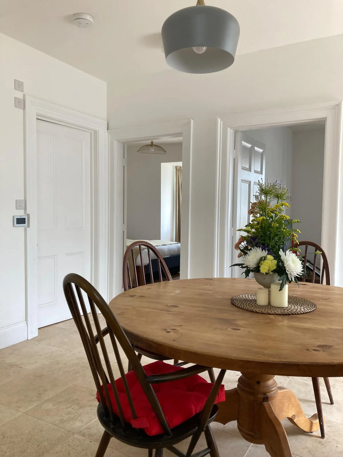 Round dining table with wooden chairs in the kitchen