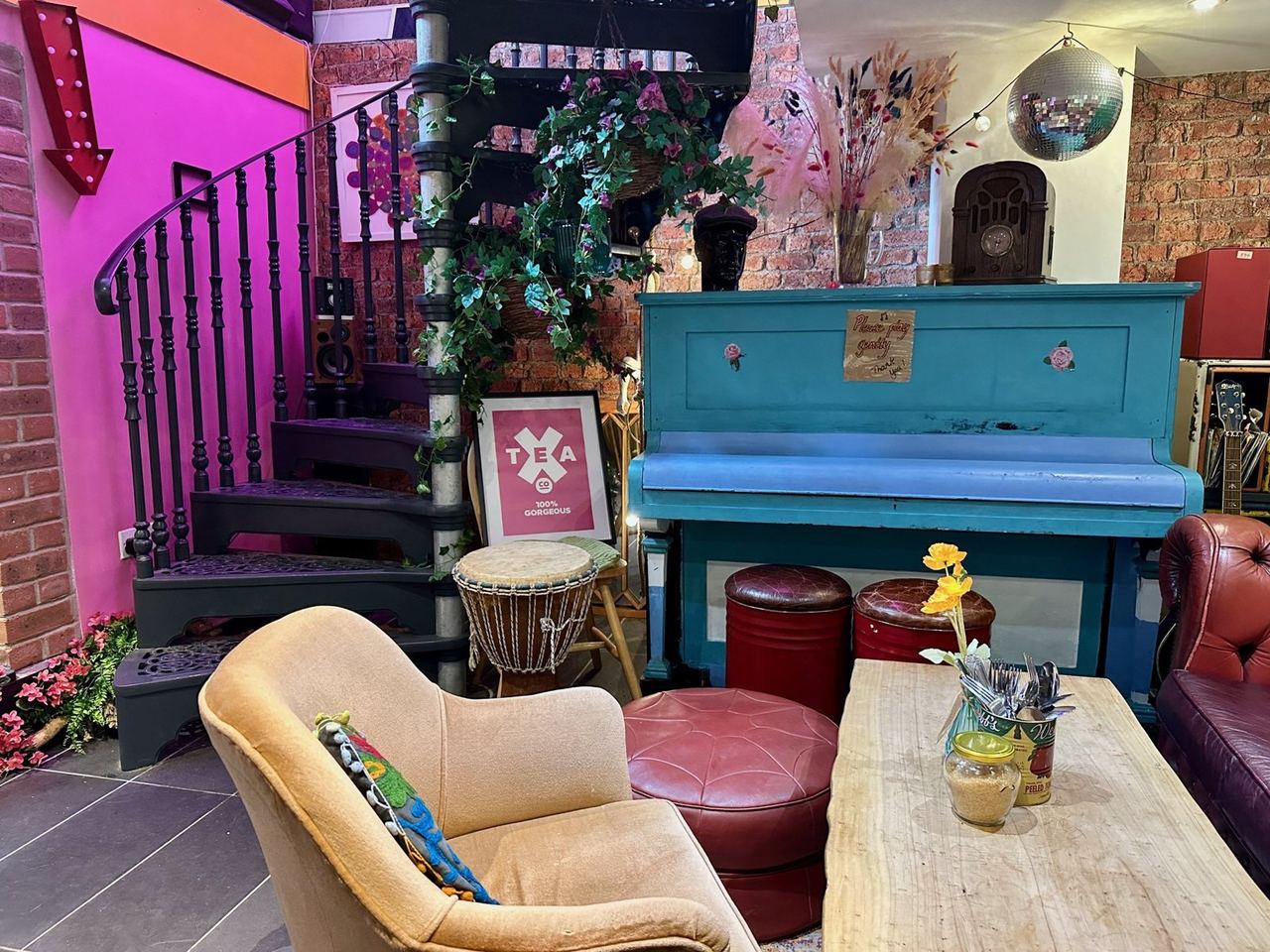 A turquoise piano and pink walls at Charlie Fridays