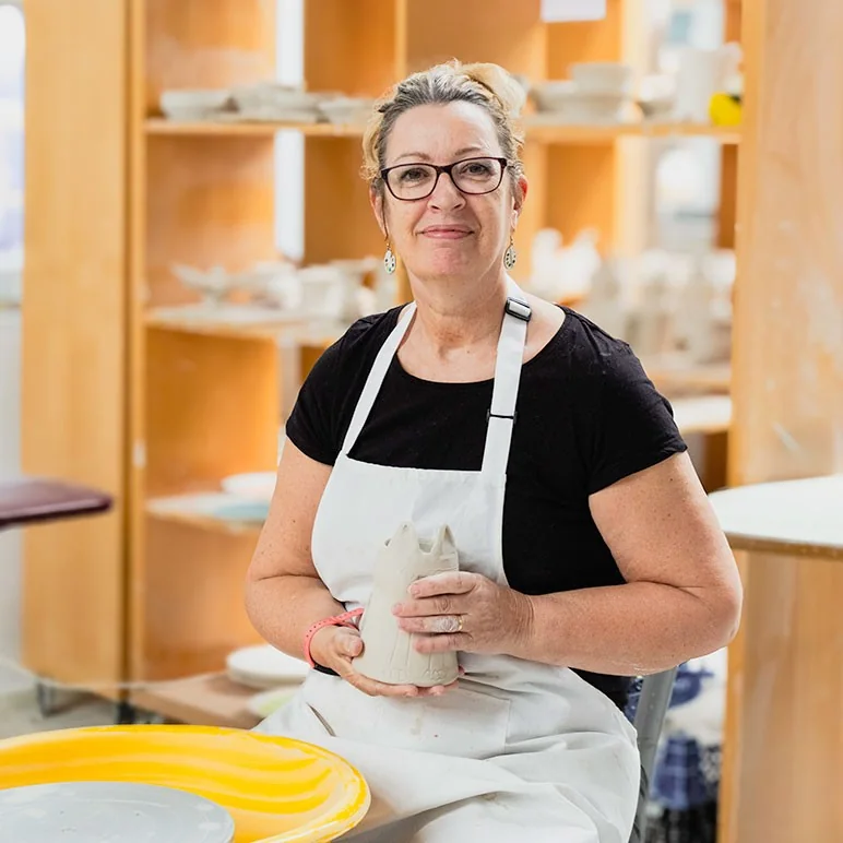 China Blue ceramic artist Susan holding pottery