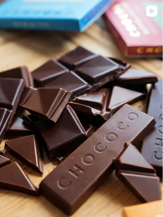 Chococo chocolate bar pieces beside colourful packaging