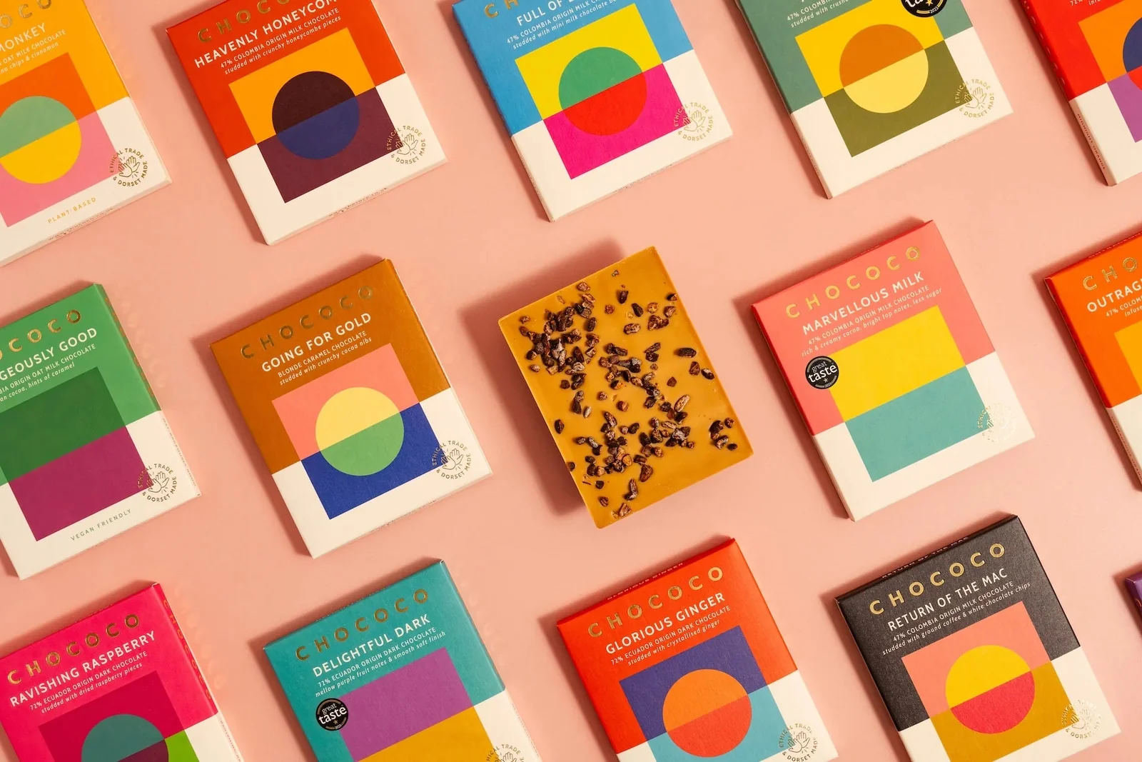 Colourful Chococo chocolate packages arranged on a pink background