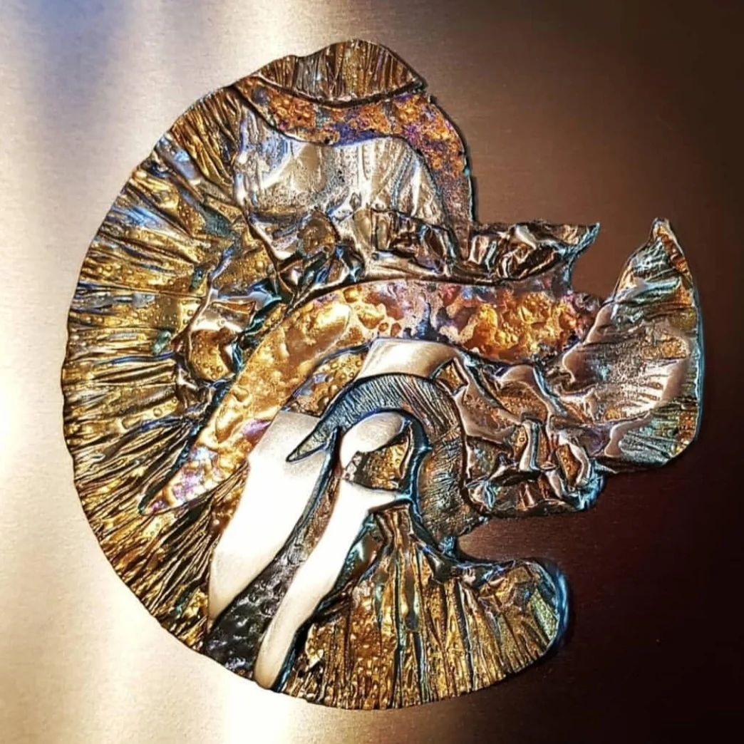Sculptural ammonite form in richly textured metal