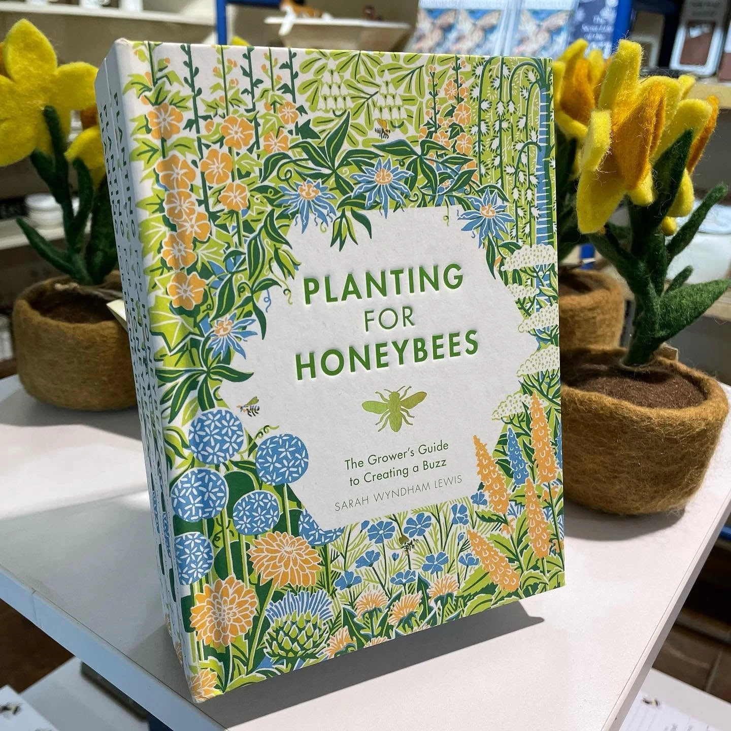 Planting for Honeybees book displayed beside yellow felt daffodils