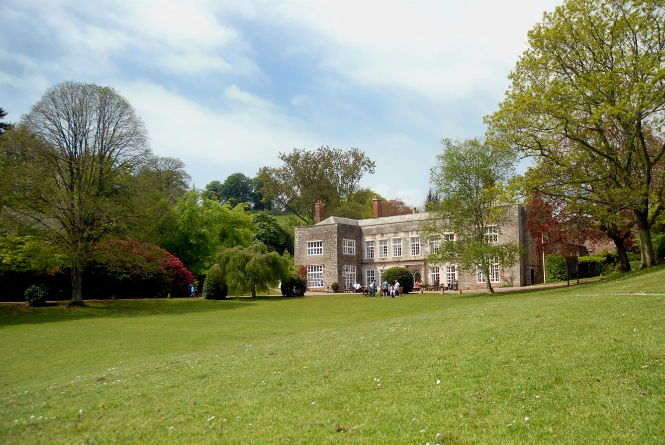 Cockington Court manor house beyond its broad green lawn