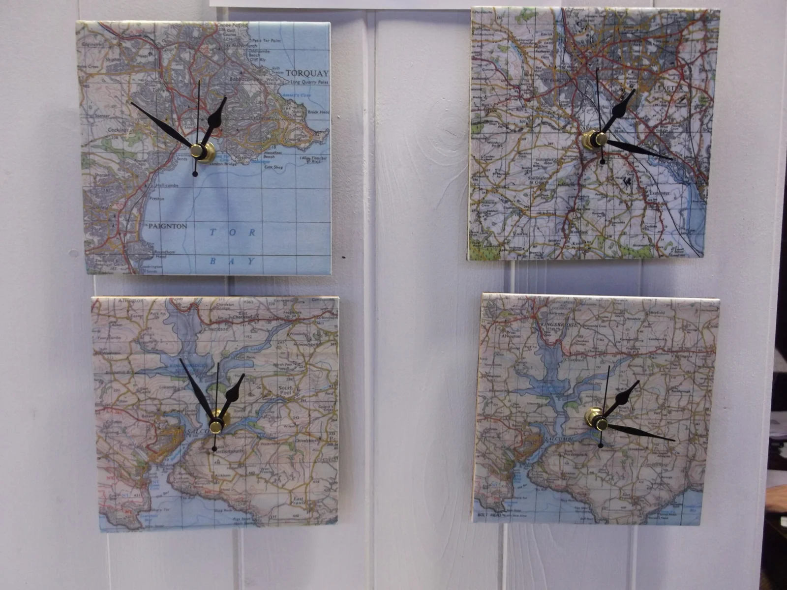 Map-faced clocks displayed in the Craft Shop