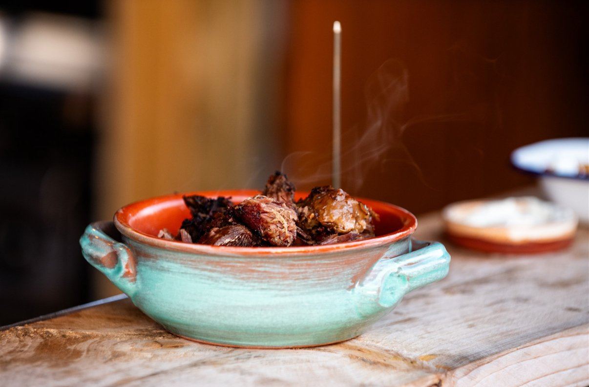 A colourful cooked dish in a turquoise ceramic bowl at Coldharbour