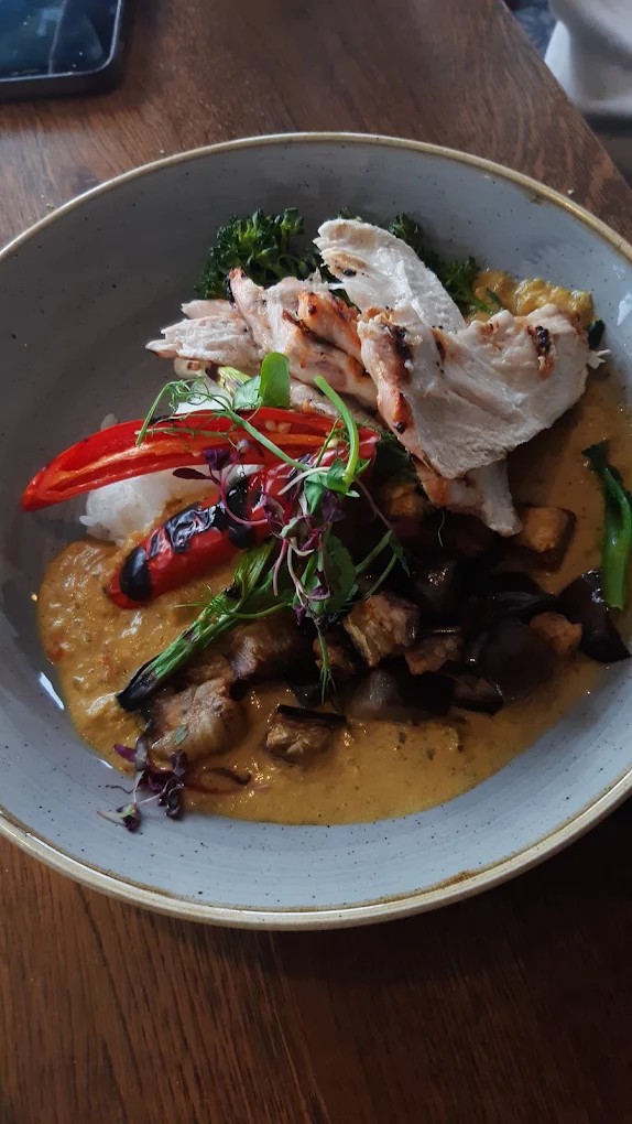 Sliced chicken with vegetables and sauce served in a bowl at The Coombe Cellars
