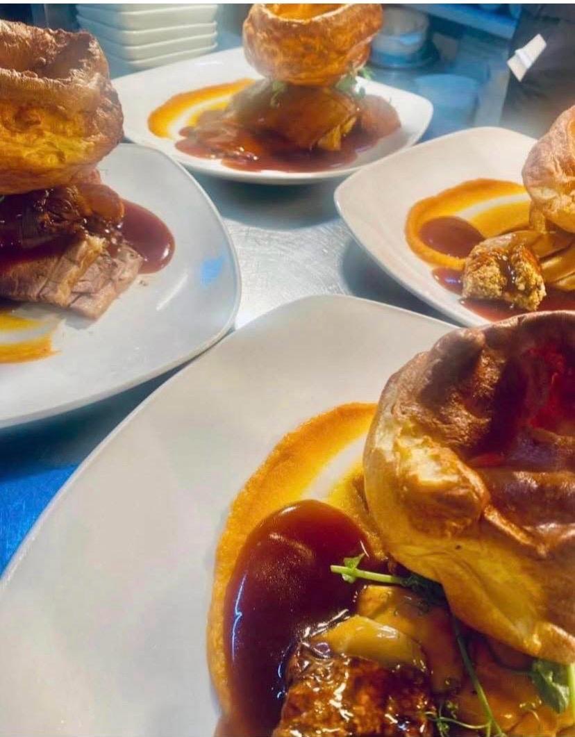 Sunday roast plates topped with golden Yorkshire puddings
