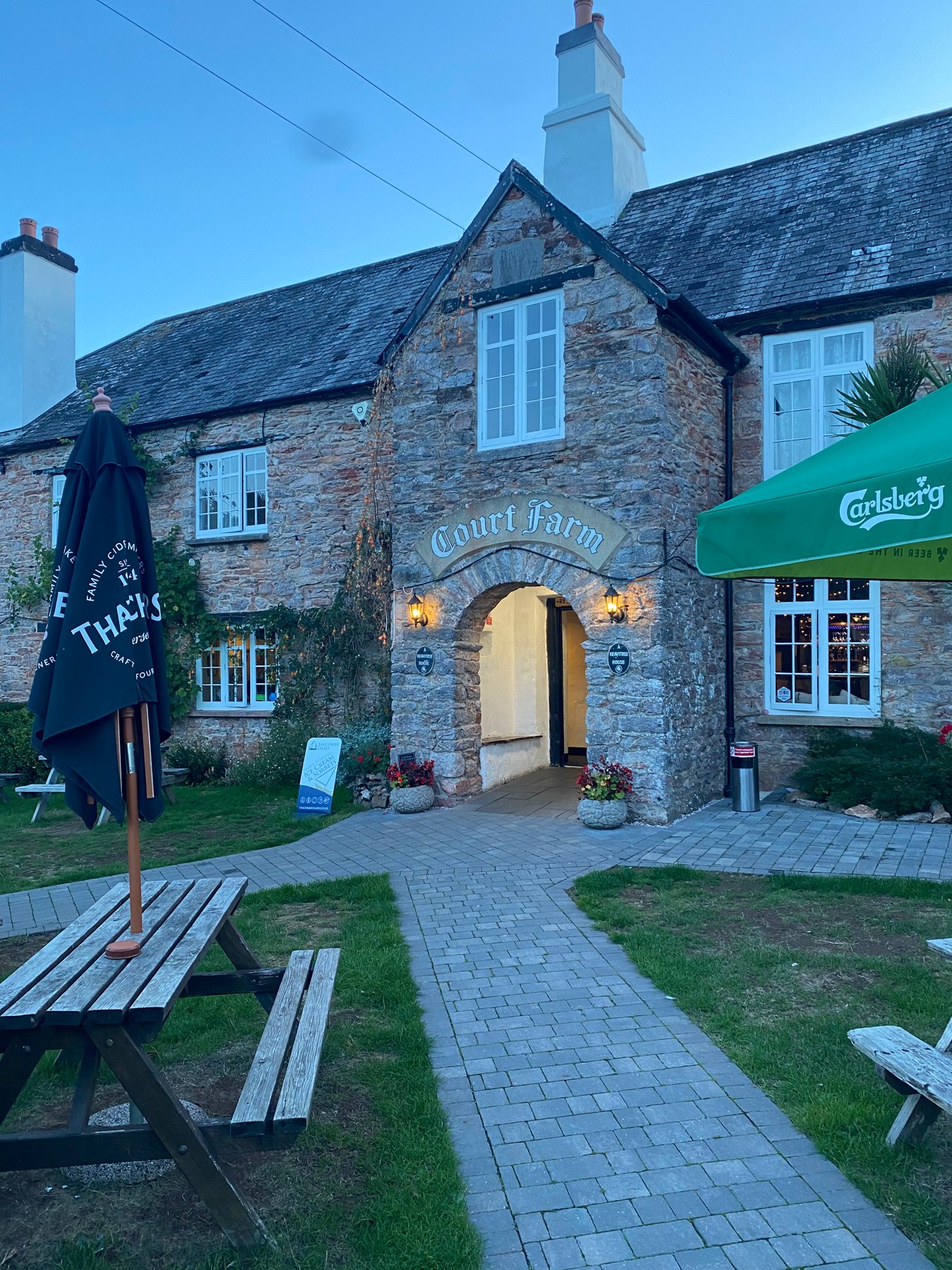 Court Farm Inn and garden tables in the early evening