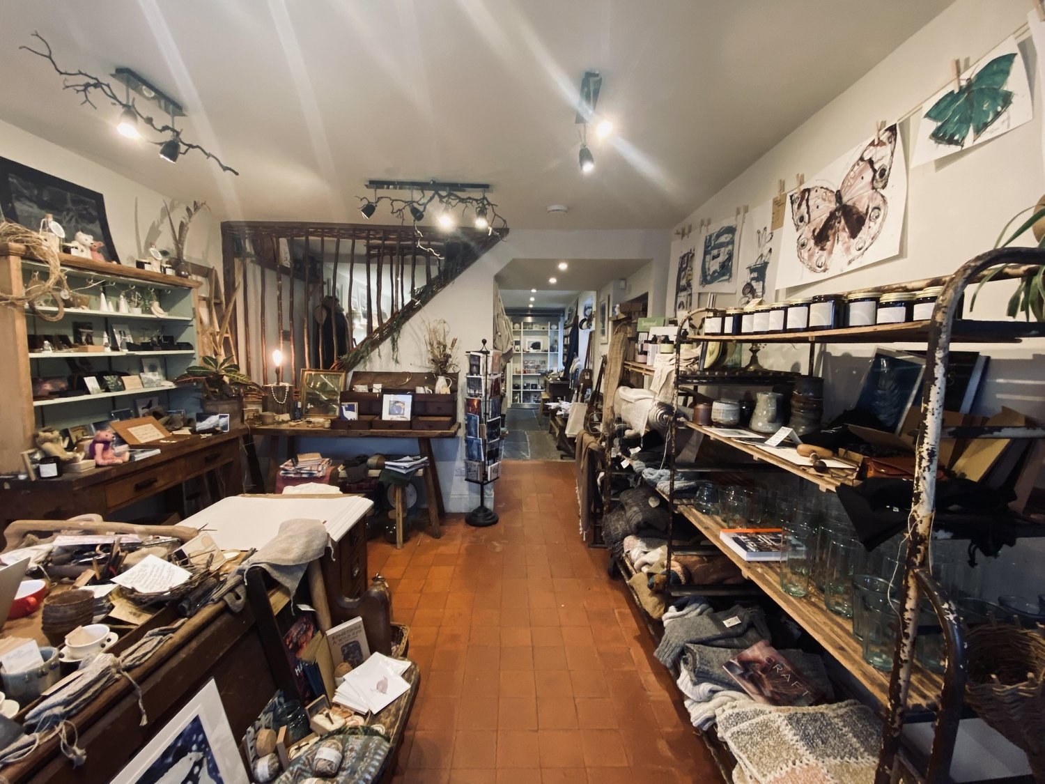 Shelves of ceramics, books and handmade objects inside Craftmongers, Ashburton