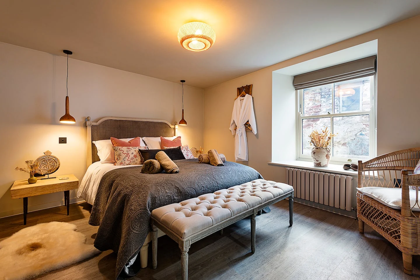 Bedroom with upholstered bed and window light