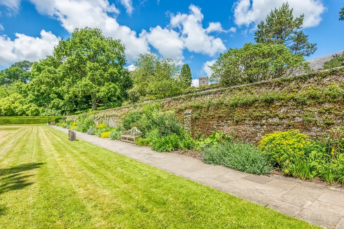 Long garden border and mown lawn at Dartington