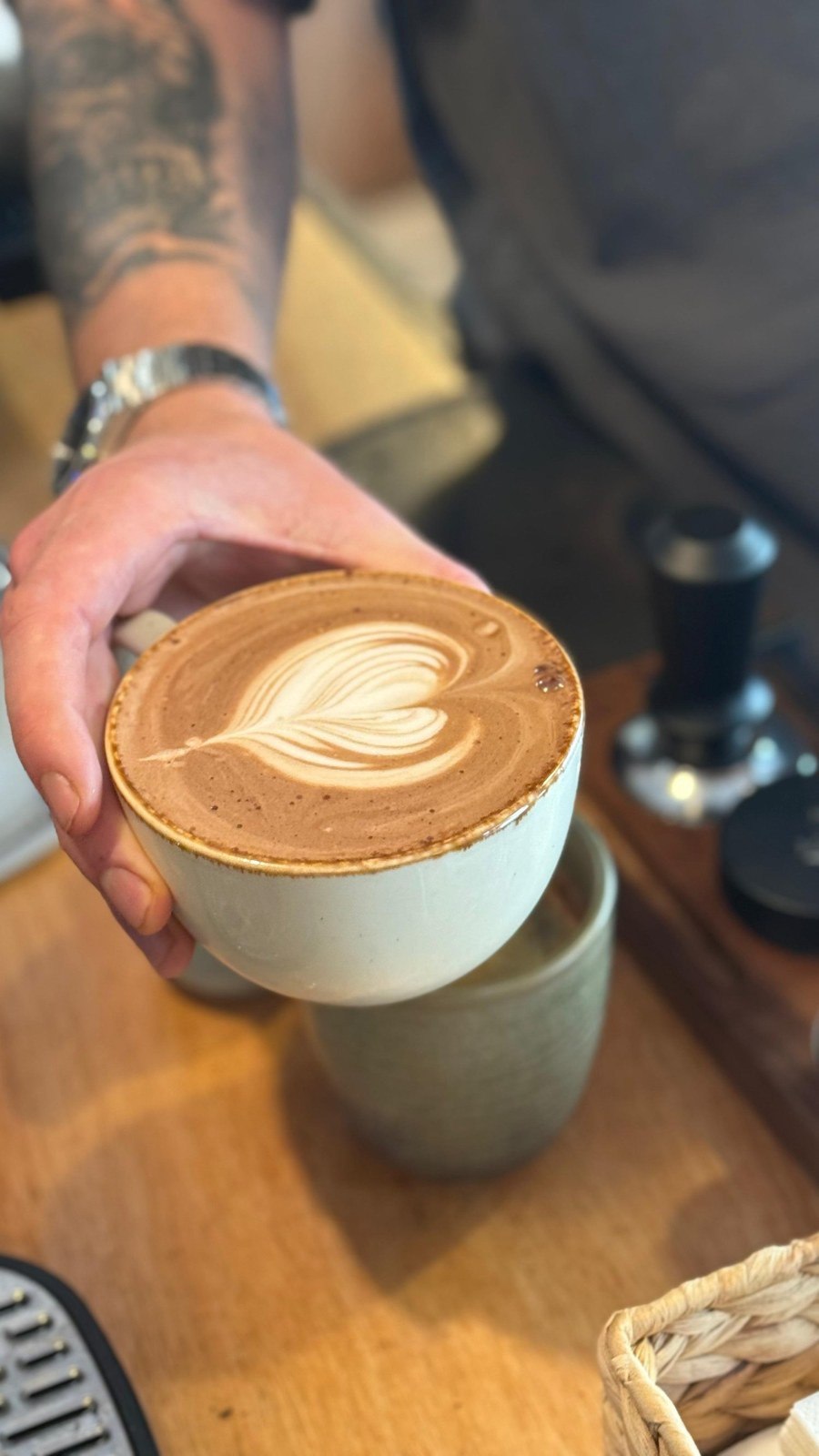 A freshly made latte with heart-shaped foam at Designs Café