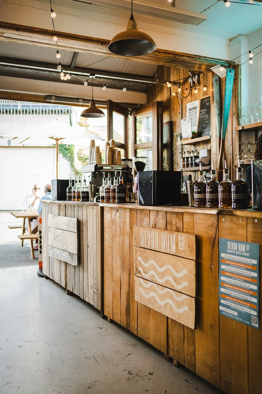 Wooden bar and stools inside Devon Rum Bar