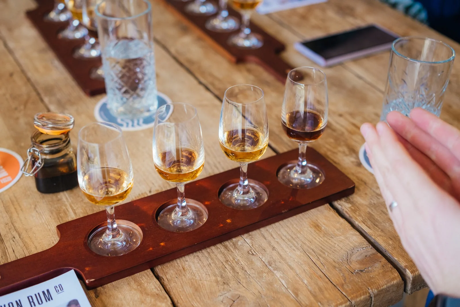 A flight of four rums laid out for tasting