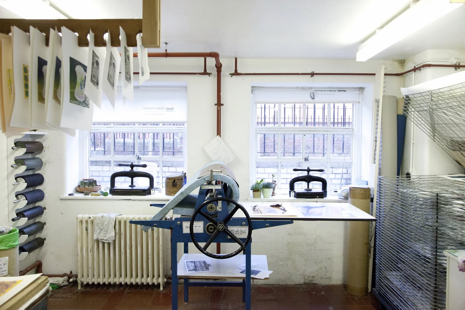 A light-filled Double Elephant workshop with printing presses and paper racks