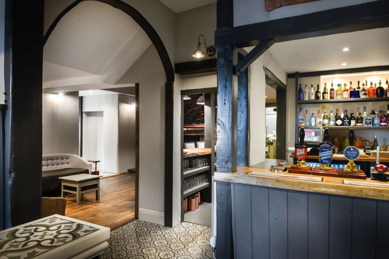 Painted timber bar and warm interior at The Duck